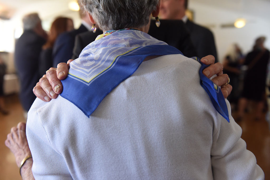 Robert Harris greets Darwin Hindman's wife, Axie Hindman during a reception